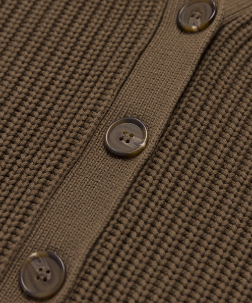 Close-up of the Cropped Cotton Cocoon Cardigan in brown, showcasing a vertical row of three round four-hole buttons on a smooth, matching placket.