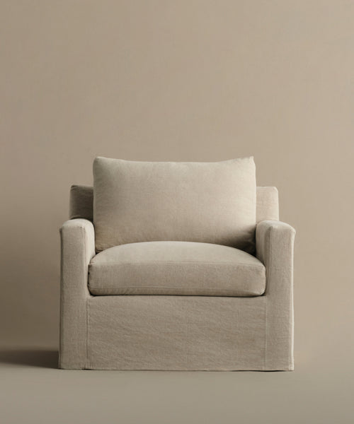 The Harbor Chair features beige Drift Linen upholstery with a boxy silhouette and plush cushioned seat and back—a cozy, inviting piece from Jenni Kayne Furniture.
