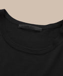 Close-up of the neckline of the Merino Tank in black, featuring a visible jenni kayne label against a beige background—perfect as a stylish base layer.