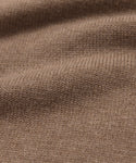 Close-up of the Simone V-Necks brown knitted cotton merino fabric, featuring a visible ribbed texture and gentle folds—showcasing its soft, cozy feel thats perfect for a luxurious layer.