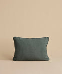 The Adler Lumbar Pillow in dark green is displayed upright against a plain beige background.