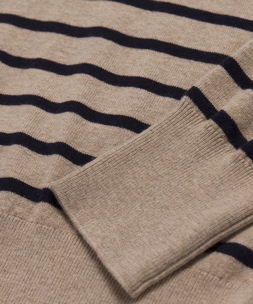 Close-up of the Avery Crewneck in beige with black horizontal stripes, showcasing the ribbed cuff and part of the sleeve laid flat.