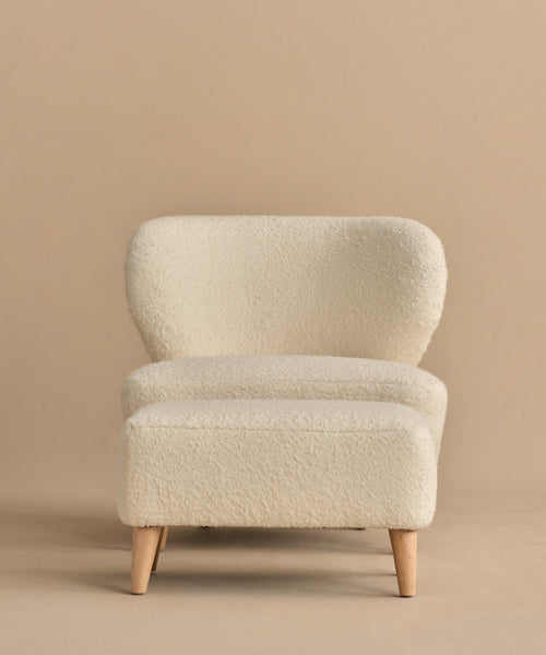 The Brentwood Chair paired with its matching foot stool creates a cozy and stylish seating option.