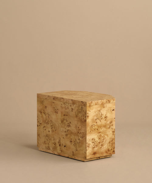 A rectangular Carbon Nightstand with a natural burl wood grain finish, set against a plain beige background.