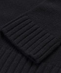 Close-up of the Cashmere Amelia Crewneck in black, highlighting the ribbed cuffs texture as it rests over the main body for a cozy, luxurious feel.
