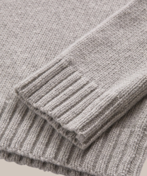 Close-up of the cuffs and hem of the Cashmere Amelia Crewneck, highlighting the ribbed texture and soft grey cashmere material.