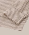 Close-up of the sleeve and hem of the Cashmere Cocoon Cardigan in beige, highlighting the ribbed knit texture and fine fabric detail.