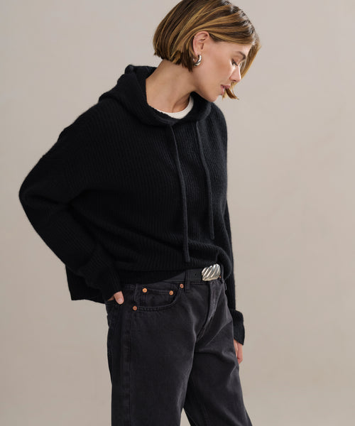 In-studio side shot of boxy cashmere hoodie with fisherman stitch.