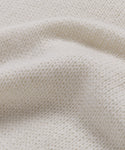 Close-up of the Cashmere Jet Turtleneck's cream-colored lightweight knit fabric, highlighting its soft texture and gentle folds—ideal for an oversized turtleneck look.