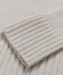Close-up of the Cashmere Jet Turtleneck’s cream-colored lightweight knit sleeve, featuring a ribbed cuff.