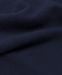 A close-up of dark navy blue fabric with a soft, smooth texture and gentle folds, perfect for the springweight Cashmere Marina Crewneck.