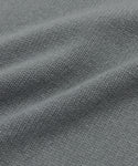 Close-up of the gray textured fabric from the Cashmere Oversized Crewneck, showcasing its visible weave pattern and soft folds that create gentle shadows.