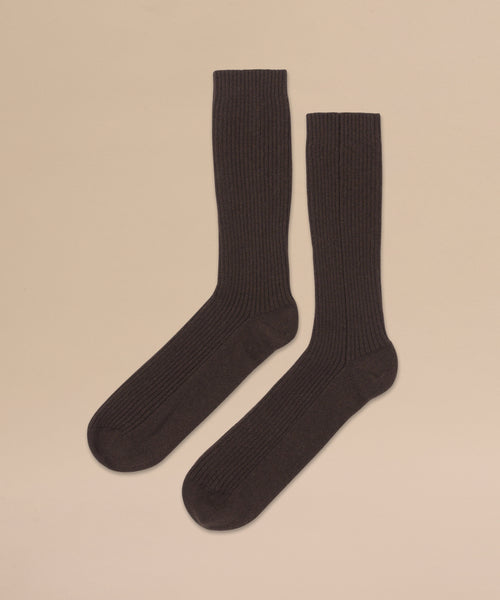 Cashmere Socks in black with a ribbed crew design are laid flat on a light beige background—perfect as a fall or winter gift.