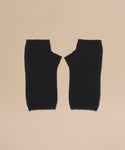 A pair of Fingerless Cashmere Gloves in black with thumb holes, displayed flat side by side on a beige background.