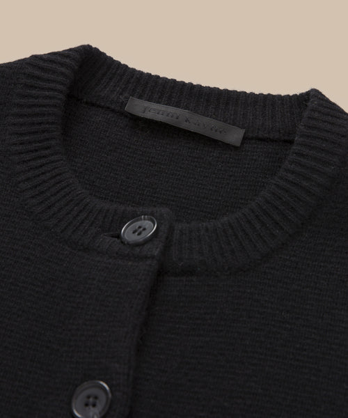 Close-up of the neckline of the Cooper Cardigan, a fitted style with a ribbed collar, two black buttons, and a subtle inner fabric label.