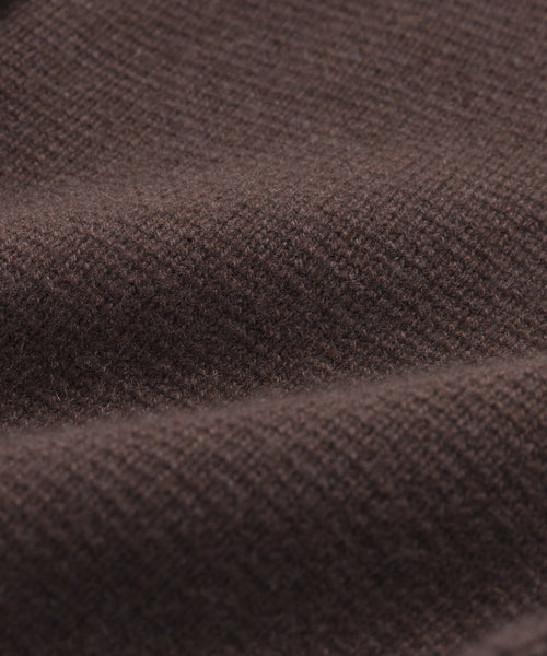 Close-up of brown textured fabric with a visible knit pattern and soft folds, ideal for showcasing the structured silhouette and versatile style of the Cooper Cardigan.