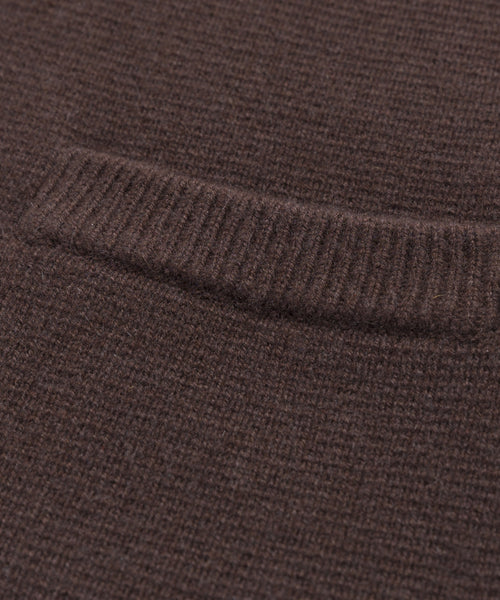 Close-up of the Cooper Cardigan, showcasing its brown knit, structured silhouette, and ribbed detailing along a horizontal seam—highlighting texture and weave for versatile styling.