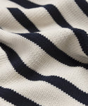 Close-up of the Cotton Kate V-Neck’s textured fabric, featuring horizontal black and white stripes with a visible knitted pattern and gentle folds—ideal for spring layering.