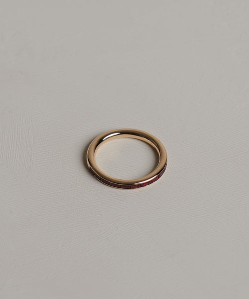 The June Baguette Band is displayed on a light grey, textured surface.