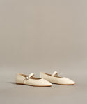 The Lana Flat is a pair of white shoes with a tapered toe, adding a touch of feminine flair.