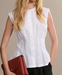 A woman wearing the Lara Top, an Italian washed poplin shirt featuring a classic button front.