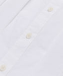 Close-up of the Lara Top, showcasing its Italian washed poplin fabric with white buttons and precisely sewn buttonholes along the front placket.