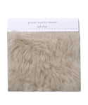 A Fabric Swatch Light Taupe Shearling offers luxurious, faux Icelandic sheep shearling softness in a light taupe hue and complements Jenni Kayne Furniture seamlessly.