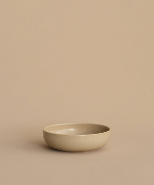 The Pacific Breakfast Bowl, crafted from beige stoneware, rests on a matching beige surface with a plain beige background.