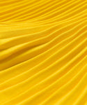 Close-up of Pleated Skirt fabric in bright yellow, featuring soft texture with evenly spaced ridges and folds for a wavy, flattering drape.