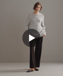 Thumbnail for video: Model walking in studio in oversized crewneck cashmere sweater.
