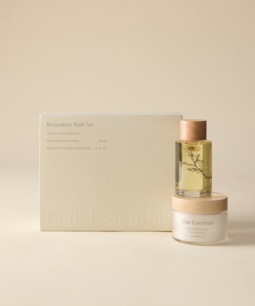 The Relaxation Bath Set features a hydrating bath oil in a clear bottle and a magnesium-infused Dream Bath Soak, both in calming neutral tones and neatly boxed for a minimalist look.