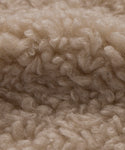 Close-up of light beige, curly, and fluffy Bone Sherpa fibers with a soft, textured look—ideal for the Fabric Swatch Bone Sherpa.