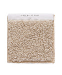 A square beige Fabric Swatch Bone Sherpa with a thick, looped texture. The white label reads Jenni Kayne Home and Bone, making it a perfect match for the Aspen Sofa or Bone Sherpa collection.