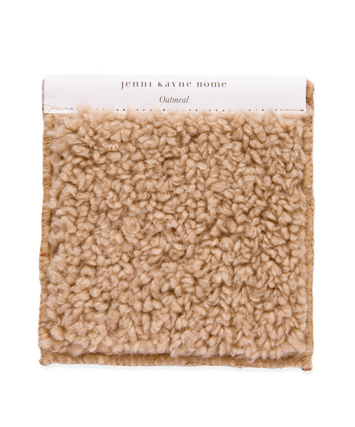 The Fabric Swatch Oatmeal Sherpa is a square sample in light beige with a plush, textured loop pile, reminiscent of cozy oatmeal sherpa. A white top label reads jenni kayne home Oatmeal.