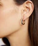 Close-up of a woman with straight brown hair and fair skin wearing the Stevie Grey Diamond Hoops—14k gold hoops with sparkling stones.