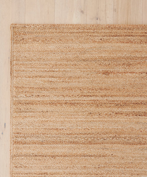 A close-up of the Sedona Jute Rug highlights its natural texture and intricate handwoven craftsmanship.