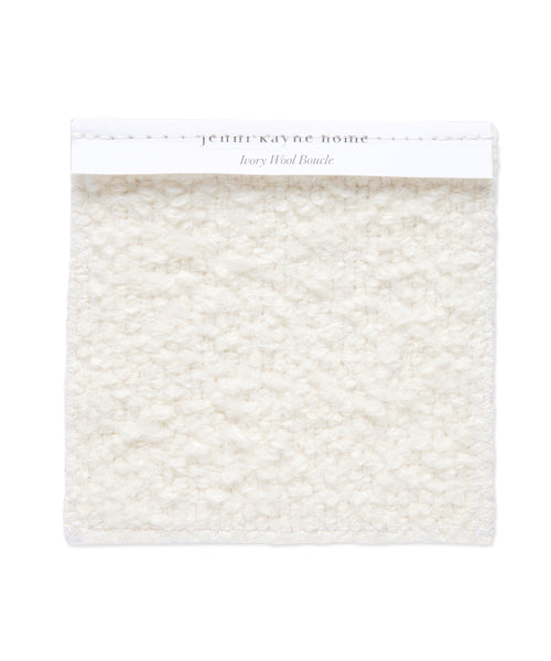 A square Fabric Swatch Ivory Wool Boucle with a soft, textured, looped surface and a white label reading Jenni Kayne Home Ivory Wool Boucle, perfect for Jenni Kayne Furniture or an upholstered bench.